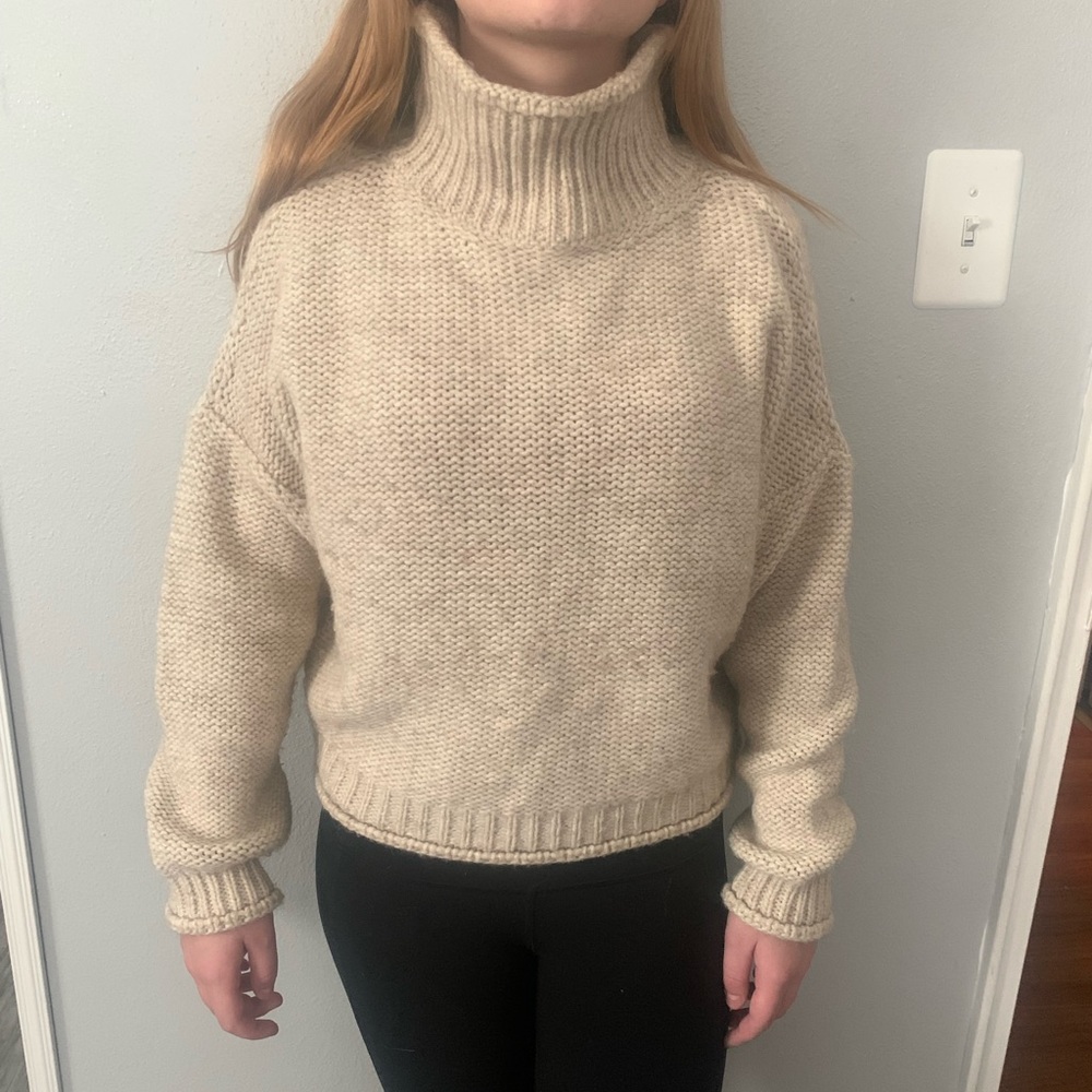 Cream colored Anthropologie loose turtleneck, cropped